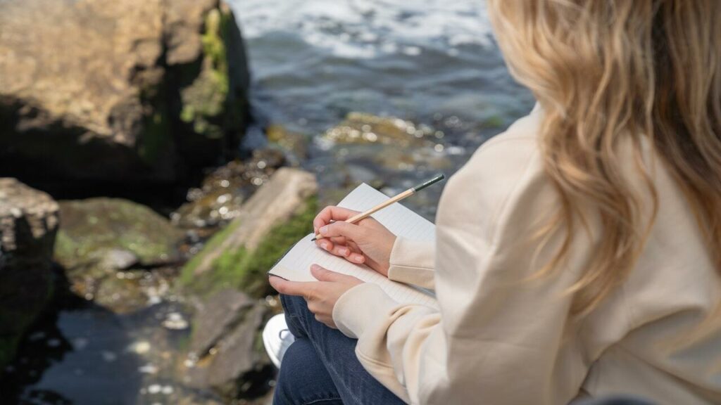 Stoic Journaling. Girl journaling by the stream.